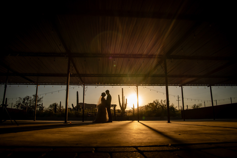 Amber sun setting as couple embraces